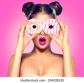 Beauty fashion model girl taking colorful donuts. Funny joyful woman with sweets, dessert. Diet, dieting concept. Junk food, Slimming, weight loss