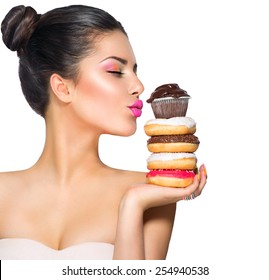 Beauty fashion model girl taking colorful donuts. Funny joyful woman with sweets, dessert. Diet, dieting concept. Junk food, Slimming, weight loss. Isolated on white background
