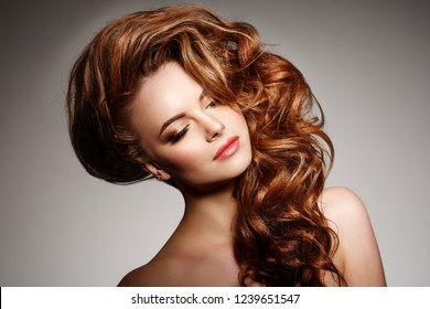 Beauty Fashion Model with long shiny  hair. Waves & Curls volume Hairstyle. Hair Salon. Updo. Woman with healthy hair girl with luxurious Updo haircut. Hair loss. - Shutterstock ID 1239651547
