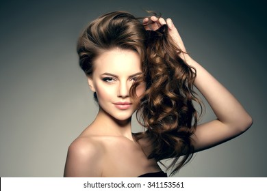 Beauty Fashion Model With Long Shiny  Hair. Waves & Curls Volume Hairstyle. Hair Salon. Updo. Woman With Healthy Hair Girl With Luxurious Updo Haircut. Hair Loss.