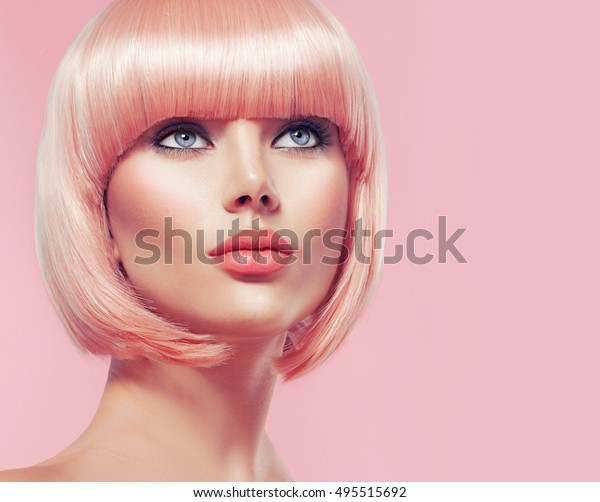 Beauty Fashion Model\
Portrait pink hair color. Bob Short Haircut. Fringe Hairstyle.\
Hairdressing. Beautiful Glamour Girl with Short blonde hair. Dyed\
hair, perfect makeup