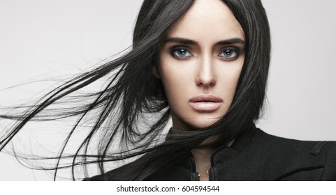 Beauty fashion portrait of young beautiful brunette girl with long black straight flying hair. Magnificent hair. Smoky eyes. Vogue style.