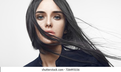 Beauty Fashion Portrait Of Young Beautiful Brunette Girl With Long Black Straight Flying Hair. Magnificent Hair. Vogue Style