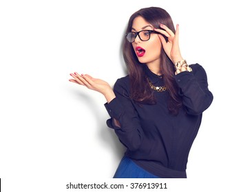 Beauty fashion sexy girl wearing glasses showing empty copy space on the open hand palm for text, white background. Happy girl presenting point. Proposing product. Advertisement gesture