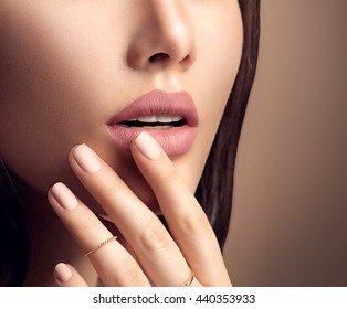 Beauty Fashion woman lips with natural Makeup and beige Nail polish. Matte lipstick and nails. Beauty girl face close up. Nude Colors. Sexy lips, Manicure, Make up