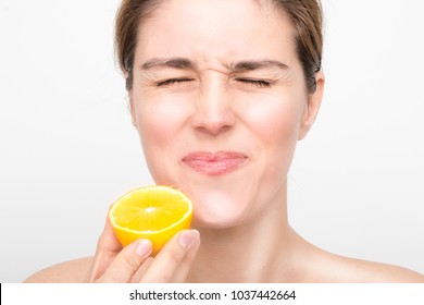 Beauty Female face with fresh lemon fruits