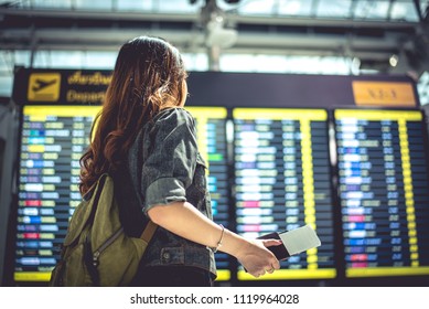 Beauty female tourist looking at flight schedules for checking take off time. People and lifestyles concept. Travel and Happy life of single woman theme. Back view portrait. - Shutterstock ID 1119964028