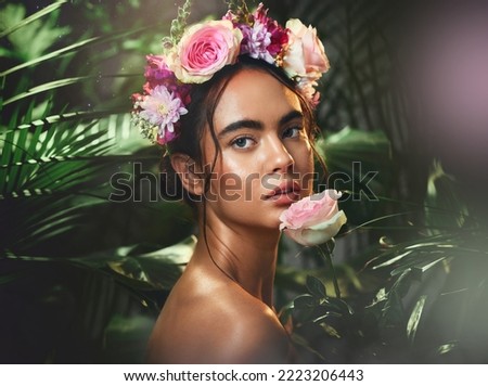 Beauty, flowers and woman with a crown in studio for skincare, cleaning and wellness with product from nature. Portrait, rose and girl model relax, pamper and cosmetic treatment, jungle and aesthetic
