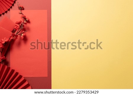 Beauty frame for Chinese New Year celebration with paper pans, lucky envelopes, red flower branch and lucky ornaments. Empty space for text and design. Background for Asia holiday