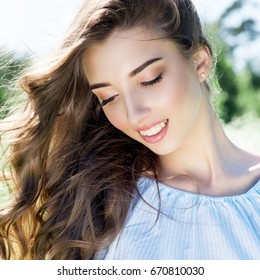 Beauty girl cute smiling long hair on the street the sun shines - Shutterstock ID 670810030