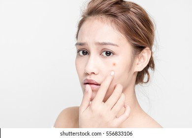 beauty girl of half latina and half asian who checks her skin, skin care, acne treatment