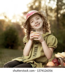 Beauty Girl With Juce In Park