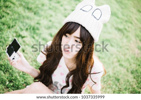 Similar – Young cheerful woman with a gift over her head