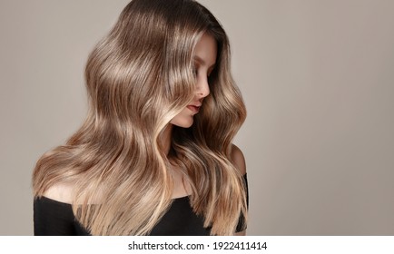 Beauty  girl with long  and   shiny wavy  Hair ,coloring and toning, shatush and balayash .  Beautiful   woman model with curly hairstyle . - Shutterstock ID 1922411414
