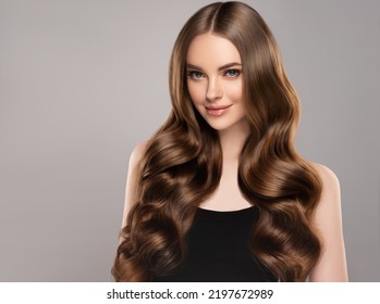 Beauty girl with long  and   shiny wavy hair .  Beautiful   woman model with curly hairstyle . - Shutterstock ID 2197672989