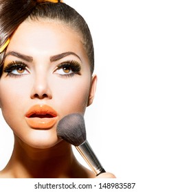 Beauty Girl With Makeup Brush. Bright Holiday Make-up For Brunette Woman With Brown Eyes. Orange And Yellow Make Up. Beautiful Face. Makeover. Perfect Skin. Applying Makeup 