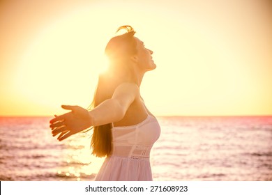 beauty girl with outstretched arms on the sea - Shutterstock ID 271608923