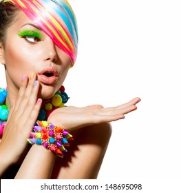 Beauty Girl Portrait with Colorful Makeup, Hair, Nail polish and Accessories. Colourful Studio Shot of Funny Woman. Vivid Colors. Manicure and Hairstyle. Rainbow Colors