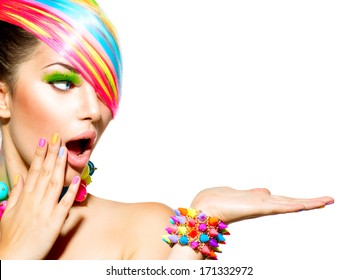 Beauty Girl Portrait with Colorful Makeup, Hair, Nail polish and Accessories. Colourful Studio Shot of Funny Woman. Vivid Colors. Manicure and Hairstyle. Rainbow Colors 