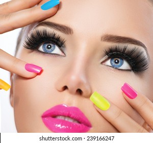 Beauty Girl Portrait With Vivid Makeup And Colorful Nail Polish. Colourful Nails. Fashion Woman Portrait Close Up. Bright Colors. Manicure Make Up. Smoky Eyes, Long Eyelashes. Rainbow Colors 