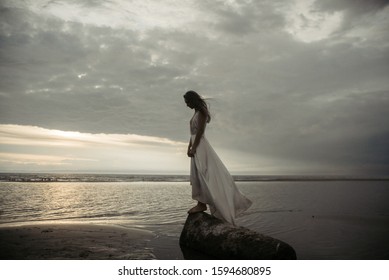 Beauty girl in white dress on sea beach 
