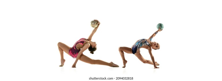 Beauty and grace. Routine with ball. Two rhythmic gymnastics artists, flexible girls in sport event isolated on white studio background. Concept of beauty, art, ad, action, study, education - Powered by Shutterstock