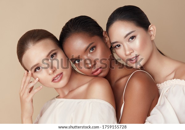 Beauty. Group Of Diversity Models Portrait. Multi-Ethnic\
Women With Different Skin Types Posing On Beige Background. Tender\
Multicultural Girls Standing Together And Looking At Camera. \
