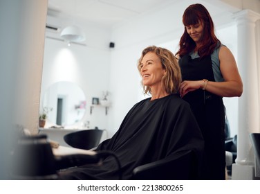 Beauty, Hairdresser And Happy Customer At A Salon For Grooming, Fancy And Beautiful Makeover. Smile, Wellness And Professional Stylist Working On An Elegant Senior Client Or Mature Woman In Canada