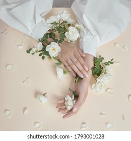 Beauty Hands Woman With Rose Flowers Are On The Table. Natural Cosmetic For Hand Skin Care. Fashion Makeup