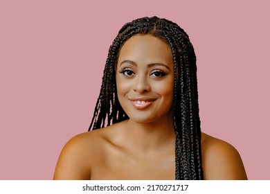 beauty headshot of young adult black woman braid hair on pink background looking at camera studio shot - Powered by Shutterstock