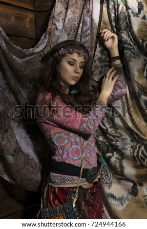 beauty hippie boho woman poses on a wooden background