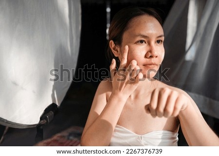 beauty at home Concept, Asian woman Applying skin care cream on the face.