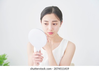 beauty image, Asian woman looking in the mirror