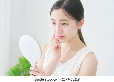 beauty image, Asian woman looking in the mirror - Shutterstock ID 2079403219