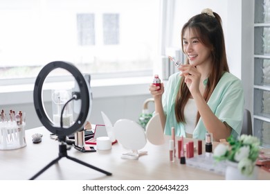 Beauty influencer concept, Young woman showing serum to introduce product and record video for Vlog. - Powered by Shutterstock