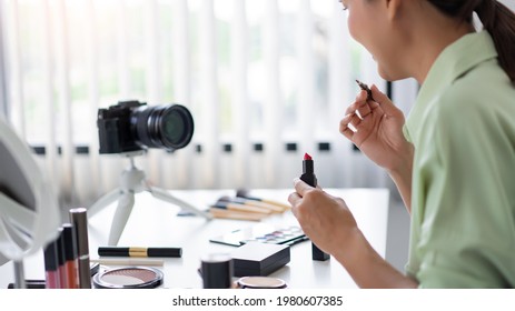 A beauty influencer confidently demonstrating how to apply makeup in professional way. - Shutterstock ID 1980607385