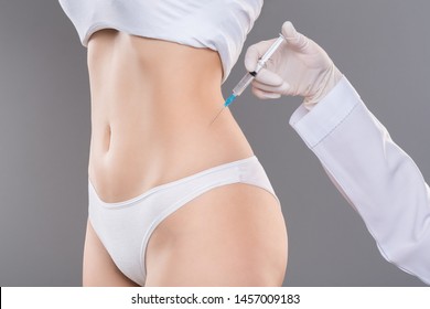 Beauty injection for slimming. Young woman getting lipolysis treatment at plastic surgery clinic, closeup - Shutterstock ID 1457009183