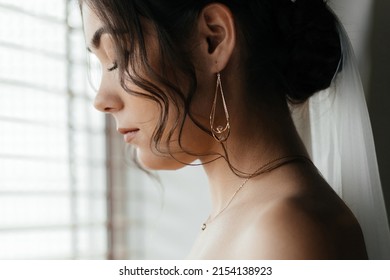 beauty, jewelry, wedding accessories, people and luxury concept - close up of beautiful asian woman or bride with earring and pendant over natural spring lilac blossom background. High quality photo - Shutterstock ID 2154138923