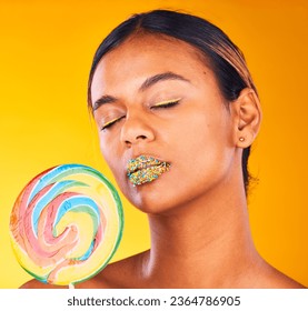 Beauty, lollipop and woman with makeup, candy and sprinkles on her lips on yellow studio background. Person, girl or model with sweet treats, aesthetic and dessert with mockup space or colorful snack - Shutterstock ID 2364786905