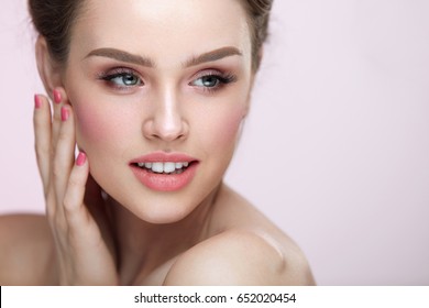 Beauty Makeup Cosmetics. Closeup Of Beautiful Woman Touching Soft Smooth Facial Skin. Portrait Of Sexy Young Female Model With Professional Natural Make-up, Pink Nails And Sexy Lips. High Resolution