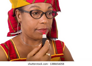 beauty, makeup and elderly concept in red african outfit - smiling senior woman applying lipstick on her lips on white background - Powered by Shutterstock