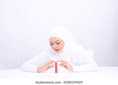 beauty makeup lips Young woman hijab beautiful elegant look lipstick both hands touch lipstick container isolated white background. cosmetic advertising concept, lip balm, lipstick container mock up - Powered by Shutterstock