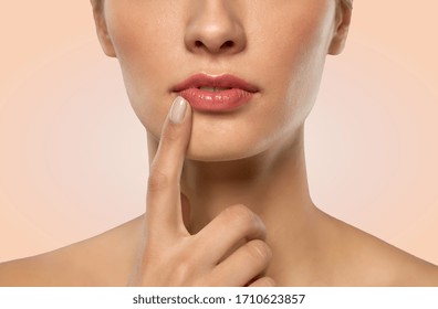 beauty, makeup and people concept - close up of beautiful young woman face and lips over beige background