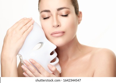 Beauty Model With Led Mask. Led Skin Rejuvenation Therapy Mask. Beauty Portrait Isolated On White