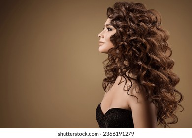 Beauty Model with Long Curly Hairstyle side view. Fashion Woman with Smooth Wavy Brown Hair. Beautiful Girl Face profile over beige - Shutterstock ID 2366191279