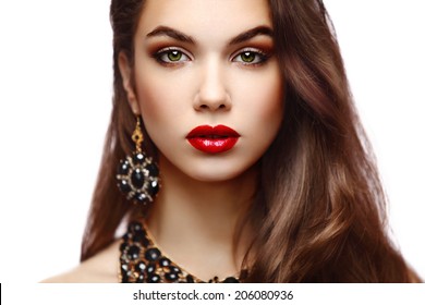 Beauty Model Woman with Long Brown Wavy Hair. Healthy Hair and Beautiful Professional Makeup. Red Lips and Smoky Eyes Make up. Gorgeous Glamour Lady Portrait.  Haircare, Skincare concept 