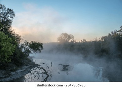 Beauty in nature: misty forest, calm river, tranquil sunrise, serene reflection, peaceful ambiance. - Powered by Shutterstock