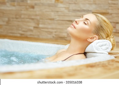 Beauty needs rest. Horizontal shot of a woman enjoying her time in the Jacuzzi with her eyes closed - Powered by Shutterstock