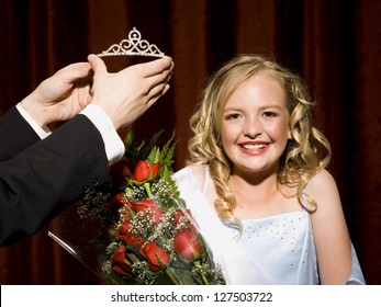 Beauty Pageant Winner Smiling, Holding Roses And Getting Her Crown