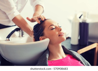 Beauty And People Concept - Happy Young Woman With Hairdresser Washing Head At Hair Salon